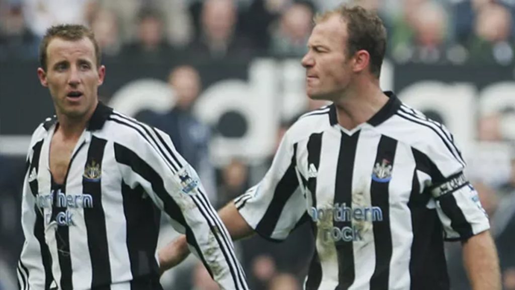 Shearer shepards Bowyer off the pitch with his shirt torn after the bust up